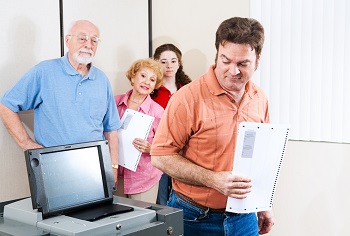 Man voting on a new touch screen machine for the first time.