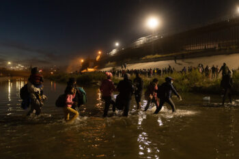 Juarez, Mexico, 12-11-2022: 1,400 migrants, mostly from Bolivia and Nicaragua, cross the border in a caravan in Juárez to surrender to the border patrol to request humanitarian asylum.